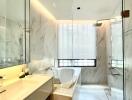 Modern bathroom with marble tiles, a glass shower, and a bathtub