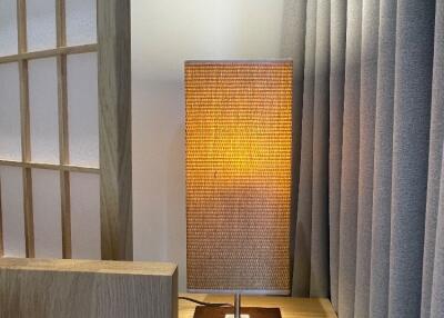 Modern bedside lamp on wooden nightstand