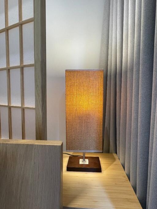 Modern bedside lamp on wooden nightstand