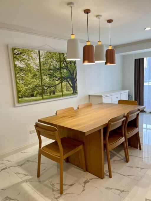 Modern dining area with wooden table and chairs