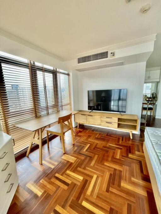 Modern living room with dining table and flat-screen TV