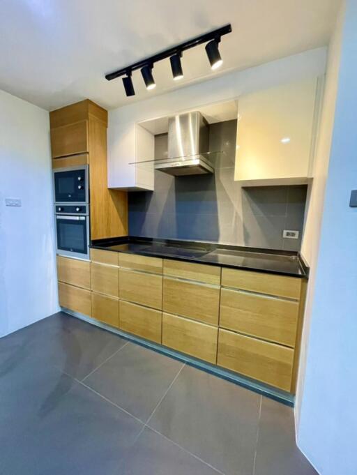 Modern kitchen with built-in appliances and track lighting