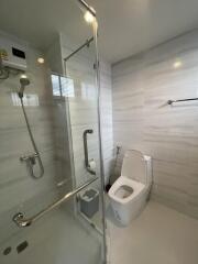 Modern bathroom with glass shower enclosure and toilet