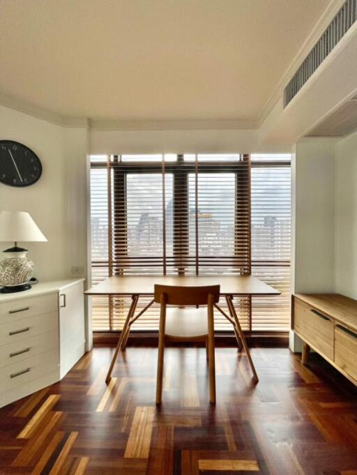 Modern living room with wooden flooring and large windows