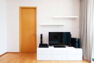 Living room with TV and wooden door