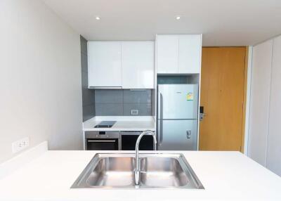 Modern kitchen with white cabinets and stainless steel appliances