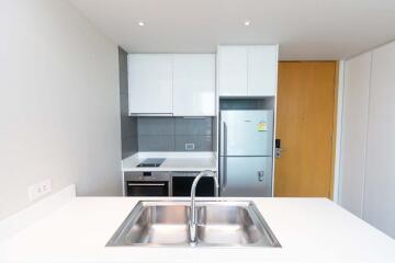 Modern kitchen with white cabinets and stainless steel appliances