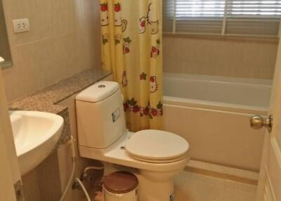 Well-lit bathroom with bathtub and Hello Kitty curtain