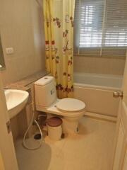 Well-lit bathroom with bathtub and Hello Kitty curtain