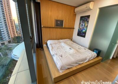 Modern bedroom with wooden accents and large window