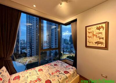 Bedroom with large windows and a city view