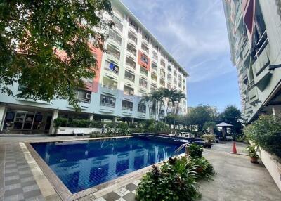 Outdoor communal swimming pool with surrounding buildings