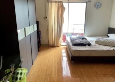 Spacious bedroom with a large bed, wardrobe, and private balcony