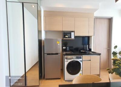 Modern kitchen with appliances and washer/dryer