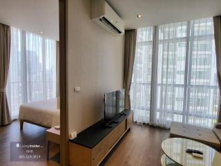 Modern apartment living room with large windows and city view