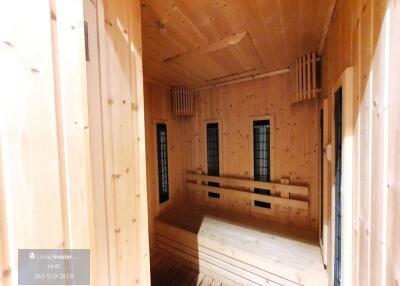 Spacious wooden sauna with bench seating