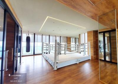 Spacious gym with a boxing ring and punching bag