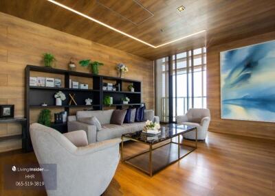 Modern living room with wooden walls and large bookshelf