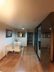 Dining area with glass table and four chairs