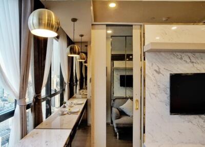 Modern living and dining area with marble finishes and large windows