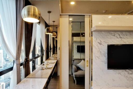 Modern living and dining area with marble finishes and large windows