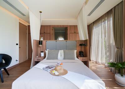 Well-lit bedroom with wooden accents and large windows