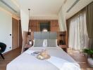 Well-lit bedroom with wooden accents and large windows