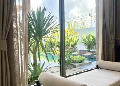 Living area with a view of the outside pool and garden