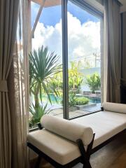 Living area with a view of the outside pool and garden