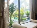 Living area with a view of the outside pool and garden