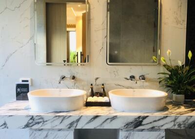 Modern bathroom with double sinks and marble finishes