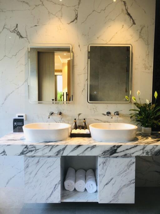 Modern bathroom with double sinks and marble finishes