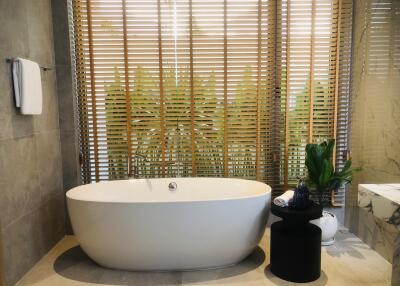 Bathroom with modern standalone bathtub and wooden blinds