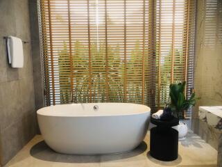 Bathroom with modern standalone bathtub and wooden blinds