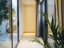 Bright hallway with large windows and plant