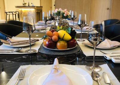 Elegant dining room with table setting and fruit centerpiece