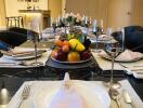 Elegant dining room with table setting and fruit centerpiece