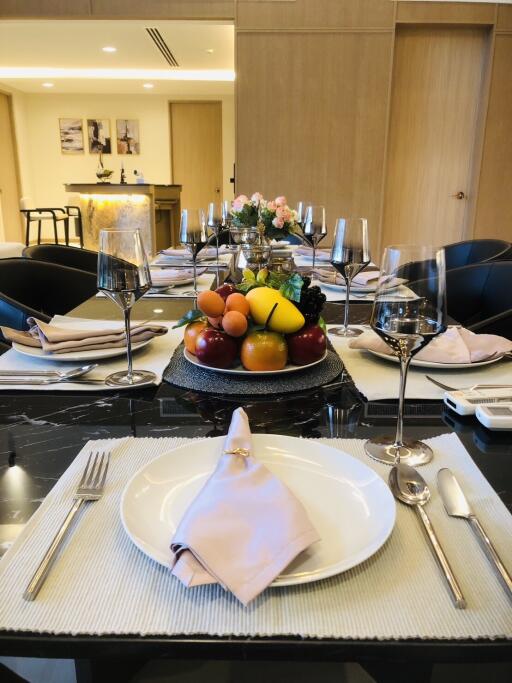 Elegant dining room with table setting and fruit centerpiece