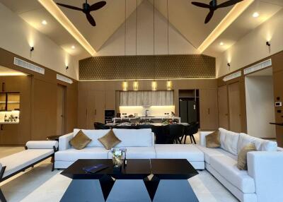 Spacious modern living room with high ceiling and open kitchen