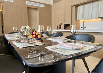 Elegant dining room with a large marble table set for a meal