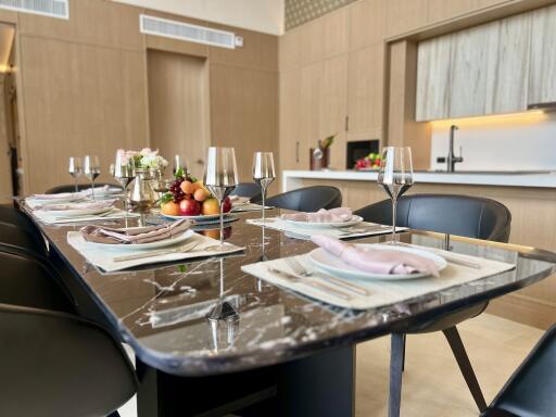 Elegant dining room with a large marble table set for a meal