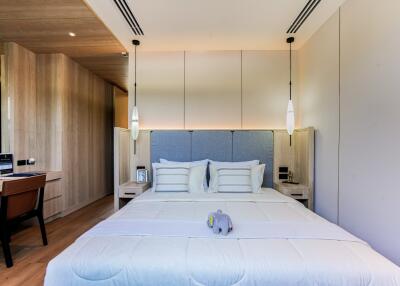 Modern bedroom with wooden accents and pendant lights