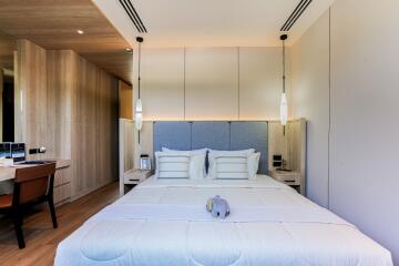 Modern bedroom with wooden accents and pendant lights