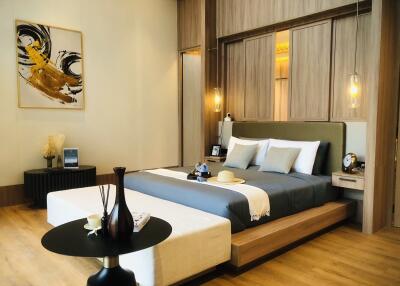 Modern bedroom with a wooden finish, artistic painting, bedside lamps, and a cozy bed.