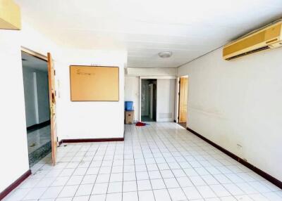 Spacious living room with tile flooring and ample natural lighting