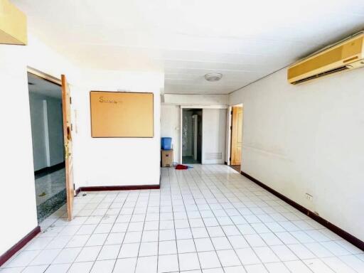 Spacious living room with tile flooring and ample natural lighting