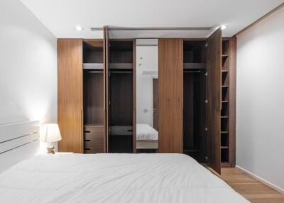 Bedroom with open closets and a bed