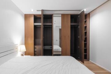 Bedroom with open closets and a bed