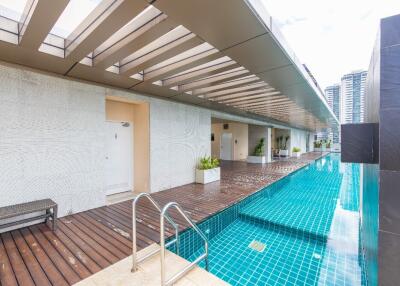 Outdoor pool area with adjacent walkway and seating