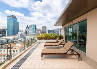 Spacious balcony with city view and lounge chairs